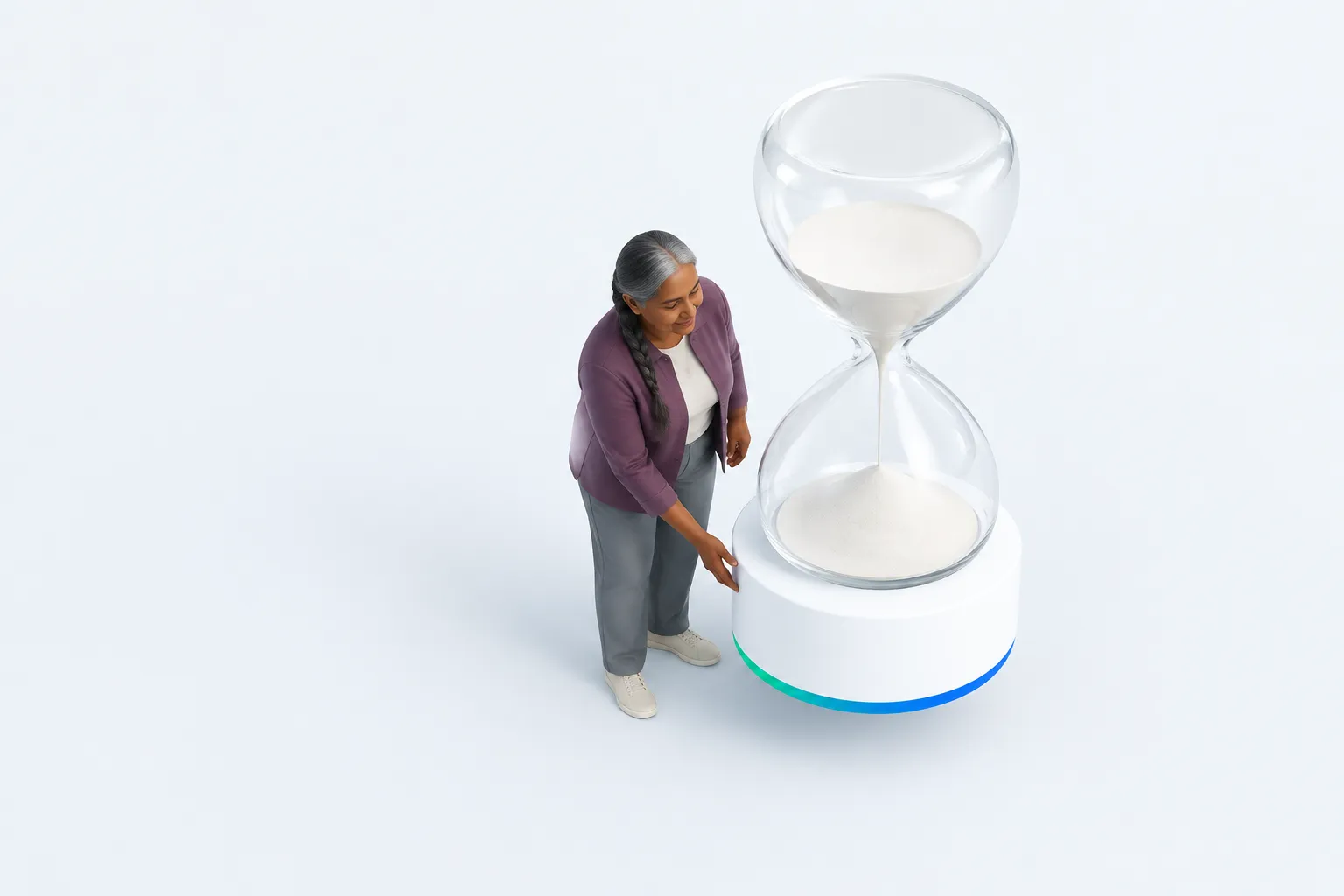 One colleague checks the removable base of an oversized glass sand timer.