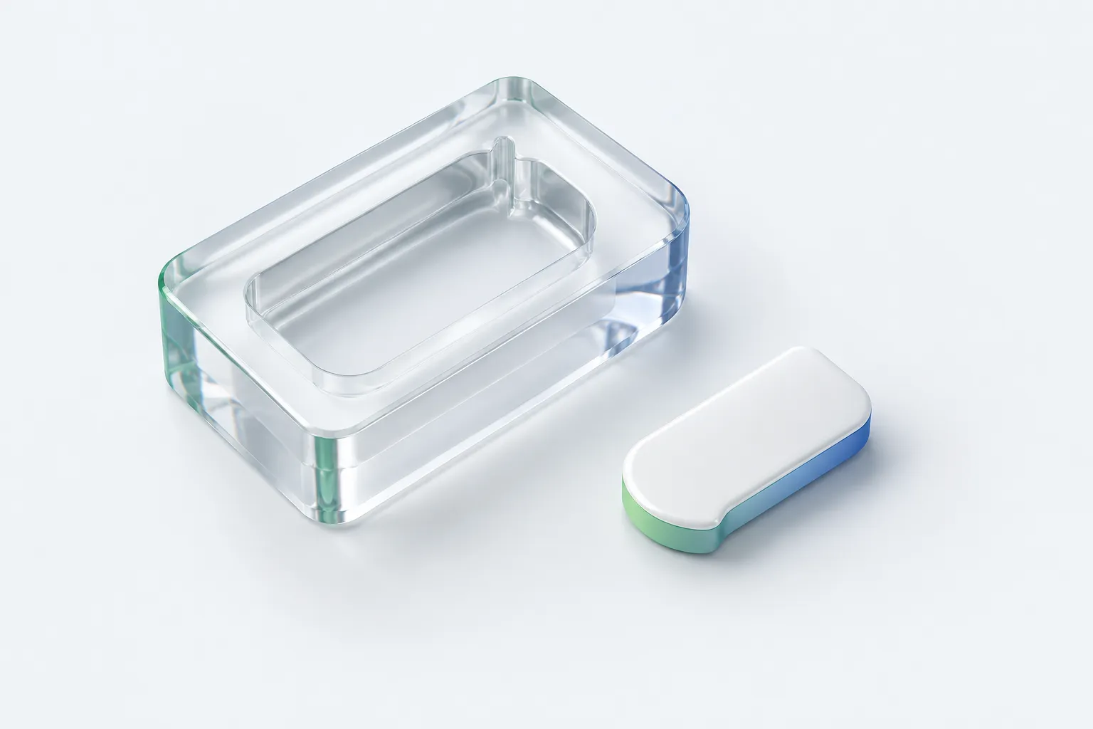 A glass casting mould beside a smaller retained component represents learning preserved after an experiment.