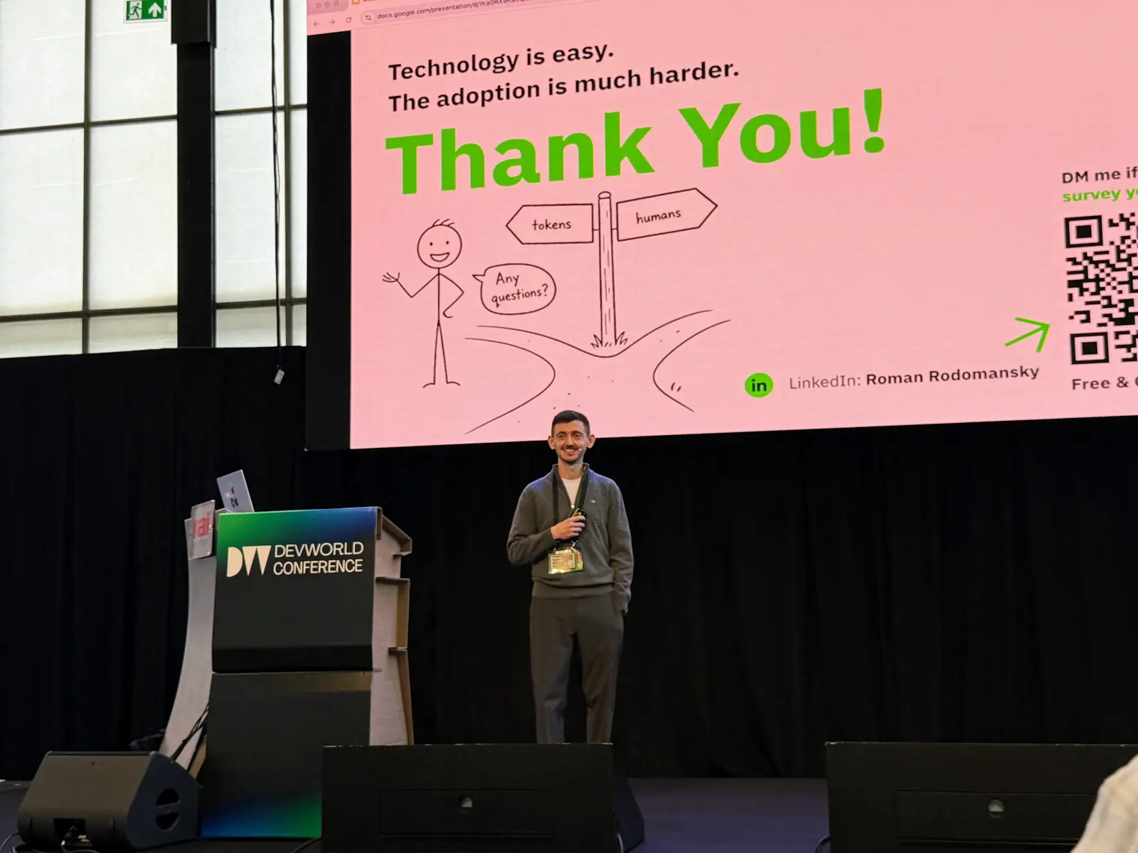 Roman on stage under the closing slide: Technology is easy. The adoption is much harder.